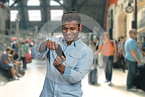 Cheerful young man palying game on his smartphone.