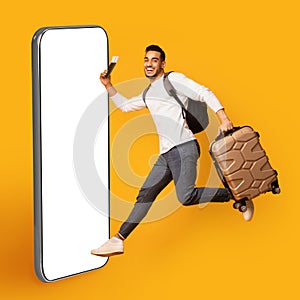 Cheerful young man traveller running towards big phone, collage