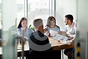 Cheerful Young Multiethnic Business Team Brainstorming Together During Corporate Meeting In Office