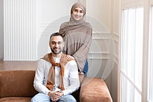Cheerful Young Muslim Family Couple Posing At Home