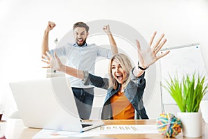 Cheerful young office workers are expressing happiness