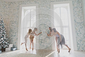 Cheerful young people cheering with champagne flutes and looking happy while having party at home