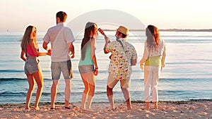 Cheerful young people rest on the nature.