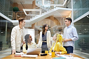 Cheerful young people in stylish casual clothes looking at each other