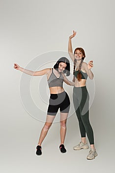 Cheerful young sportswomen with vitiligo and