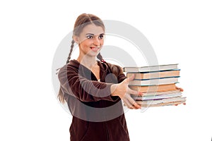 Cheerful young student girl with books in brown sport clothes smiling isolated on white background. student years