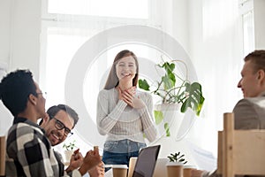 Cheerful young team in office at work