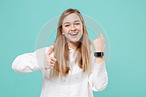 Cheerful young woman in casual white hoodie posing isolated on blue turquoise background studio portrait. People