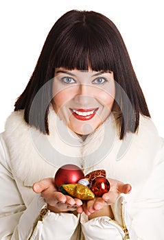 Cheerful young woman with Christmas toys
