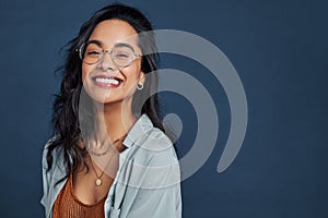 Cheerful young woman with eyeglasses smiling and looking at camera