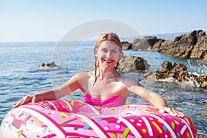 Woman holding inflatable doughnut