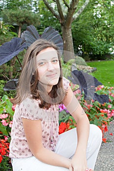 Cheerful young woman on home garden spring day