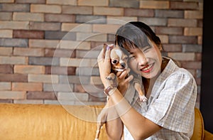 Happy Asian female with small dog