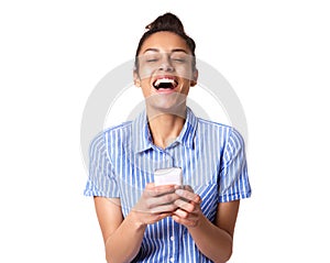 Cheerful young woman laughing with mobile phone