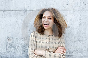 Cheerful young woman laughing outdoors