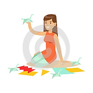 Cheerful young woman making origami cranes from colorful papper. Craft hobby and profession colorful character vector