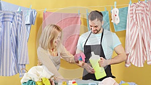 Cheerful young woman and man rejoicing at good detergents