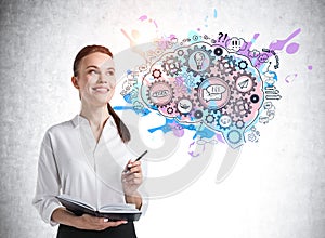 Cheerful young woman with notebook and colorful brain sketch