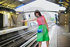Cheerful young woman in Parisian underground