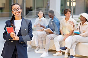 Cheerful young woman posing over multicultural group of students