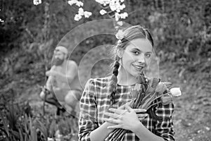 Cheerful young woman potting flowers. Gardening concept.