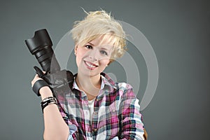 Cheerful young woman with reflex camera