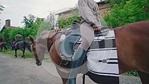 Cheerful young woman rides backwards on a horse