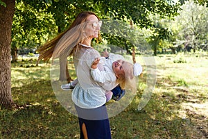 Cheerful young woman and two-year-old girl