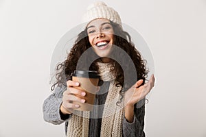 Cheerful young woman wearing winter scarf standing