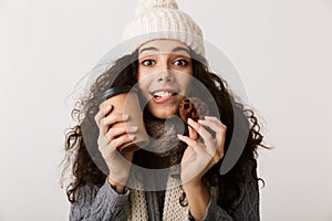 Cheerful young woman wearing winter scarf standing