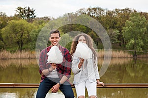 Cheerful youngsters with cotton candy