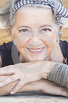 Cheerful youthful old senior woman smile portrait looking on camera with trendy make up and accessories