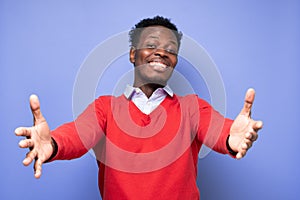 Cheerfull african man wanting to cuddle, smiling broadly