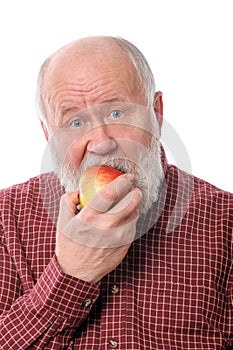 Cheerfull senior man eating the apple, isolated on white