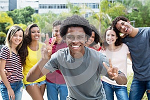 Cheering african american guy with group of international friend