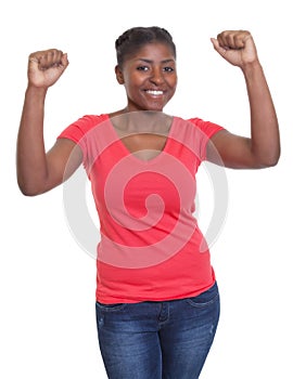 Cheering african american woman in a red shirt and jeans