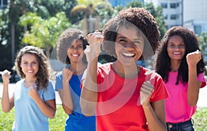 Cheering african american woman with small group of latin and caucasian girls