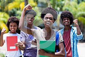 Cheering african female student with group of african american students