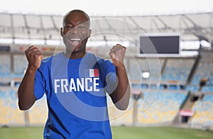 Cheering african french soccer fan at stadium