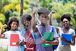 Cheering african male student with group of african american students