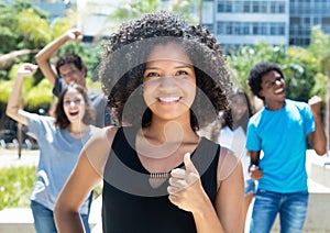 Cheering african woman with caucasian and latin man