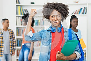 Cheering afro american male student with group of black young adults