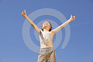 Cheering boy posing thumbs up