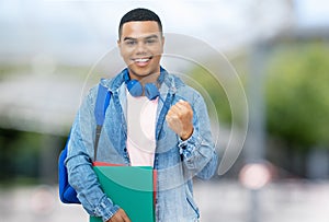 Cheering brazilian male student with braces