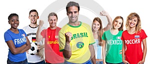 Cheering brazilian soccer supporter with fans from other countries