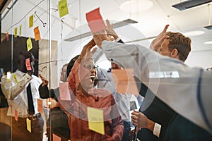 Cheering businesspeople high fiving together during a brainstorm photo