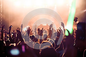 Cheering crowd with hands in air at music festival