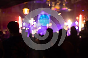 Cheering crowd at a party concert. Silhouettes of audience people at live concert stage show. Happy fan cheer musician band, nigh