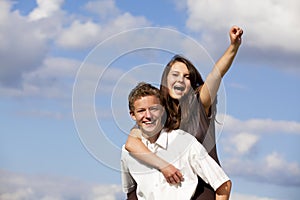 Cheering happy teenage couple