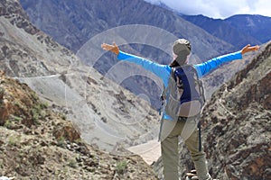 Cheering hiking woman enjoy the beautiful view at mountain peak